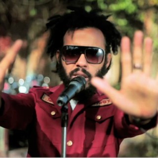 Protoje - Shot By Love (Feat Toi) - Tekst piosenki, lyrics - teksciki.pl